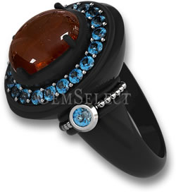 Anillo de metal negro con piedra central de cabujón de espesartita y halo de topacio azul