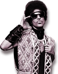 Prince in a Jewel-Encrusted Balmain Silver Vest and Breastplate Necklace