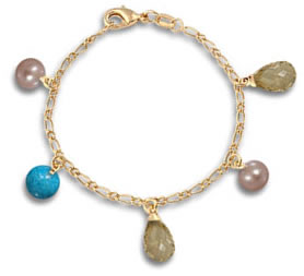 Pulsera de dijes de oro amarillo y piedras preciosas