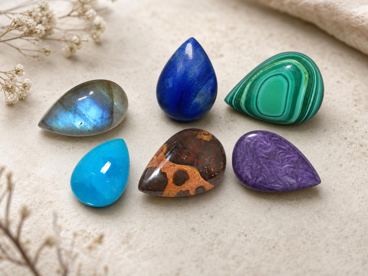 Loose cabochon teardrop gemstones in assorted natural colors