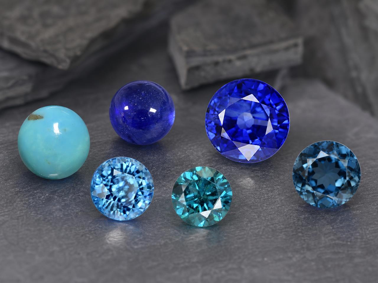 Selection of loose round blue gemstones in different shades