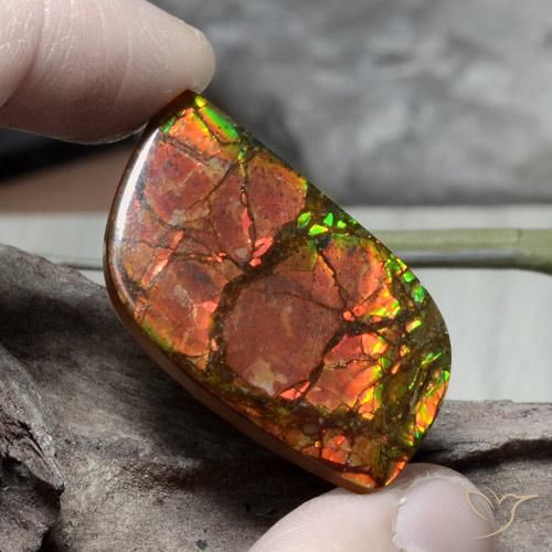 32.4x17.7 mm Fancy Cabochon Multicolor Ammolite from Canada, Weight of 26.89ct, Natural assembled gemstone in Opaque Clarity, 1pc Ammolite - the Color is Multicolor, Mohs Hardness of 4 - 4, Photo A