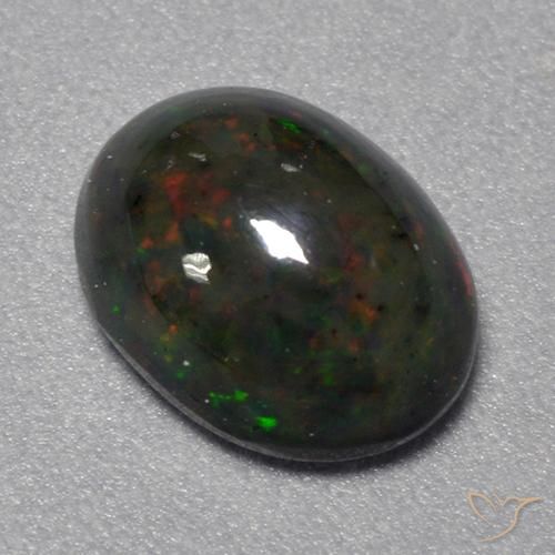 Opale Noir Multicolore Ovale 1,22 ct d'Éthiopie, Dimension 9 x 7mm, Pierre gemme naturelle Fumé, pureté Translucide, 1 pièce d'opale noire oval cabochon, dureté de Mohs de 5.5 à 6.5, Photo A