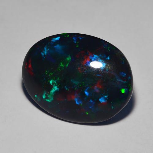 Opale Noir Multicolore Ovale 6,39 ct d'Éthiopie, Dimension 17,3 x 13,3mm, Pierre gemme naturelle Fumé, pureté Translucide, 1 pièce d'opale noire oval cabochon, dureté de Mohs de 5.5 à 6.5, Photo A