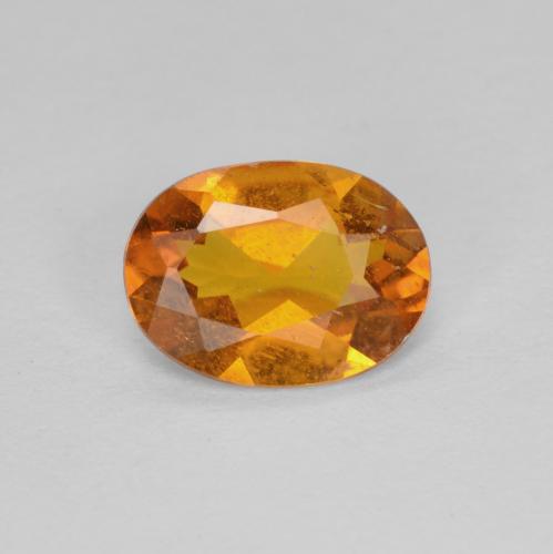 Earth Orange Klinohumit Edelstein - 0.9ct Oval facettiert (ID: 604654)