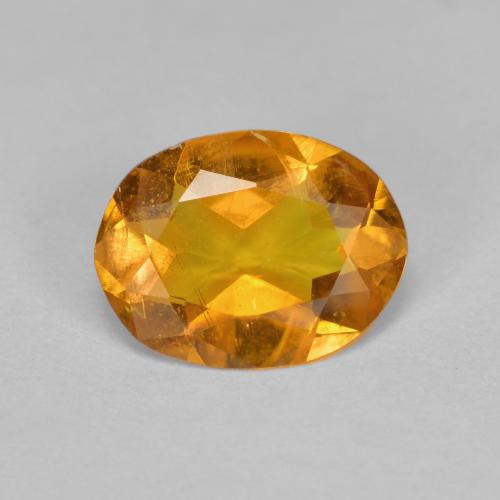 Cider Orange Klinohumit Edelstein - 1.3ct Oval facettiert (ID: 606574)