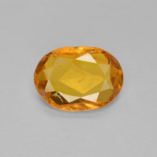 Medium Orange Klinohumit Edelstein - 0.9ct Oval facettiert (ID: 606578)