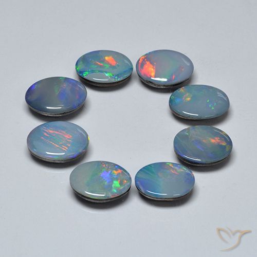 8-teiliges ovaler mehrfarbiger Opal-Dublette / Set aus Australian - Gewicht 6,24 ct gesamt / Durchschn. je 0,78 ct, Größe 8,2 x 6mm, Farbe: Mehrfarbig, Mohs-Härte 5,5 - 6,5, Photo A