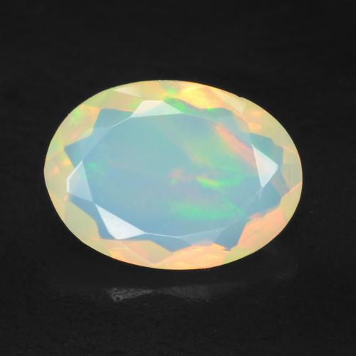 Ópalo Multicolor Forma ovalada de 0.96 ct de Etiopía, dimensión 9,5 x 6,9mm, piedra preciosa natural No tratado, claridad Transparente, Ópalo de 1 pieza en color Multicolor, dureza Mohs de 5.5 - 6.5, Simboliza el amor, la pasión, el deseo, Photo A