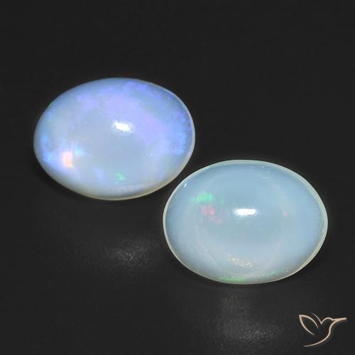 Par de Ópalo Ovalada a juego de 7,9 x 6,1mm - Peso 1,5 ct en total / promedio. 0,75 ct cada uno, color Multicolor en claridad Transparente, piedra preciosa natural No tratado, dureza de Mohs 5.5 - 6.5, Año de la piedra preciosa de la serpiente, Photo A