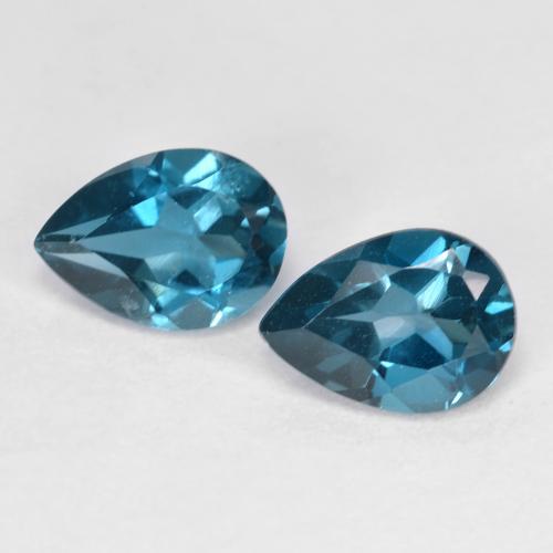 Matching Pair of 7 x 5.1mm Pear Facet Blue Topaz, Weight of 1.72ct total / avg. 0.86ct each, Matching Topaz Pair in VVS-VS Clarity in Deep Navy Blue Color, Natural irradiated gemstone, Mohs Hardness 8 suitable for daily wear jewelry, November Birthstone, Photo A