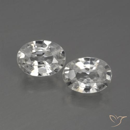 2 Zircons Ovale assorties de 6,9 x 5mm, poids total de 1,96 ct / moyenne de 0,98 ct chacune, Blanc à pureté vvs, pierre gemme naturelle , dureté Mohs de 6.5 à 7.5 convient aux bijoux de tous les jours, pierre de sagesse, Expose une grande brillance, Photo A